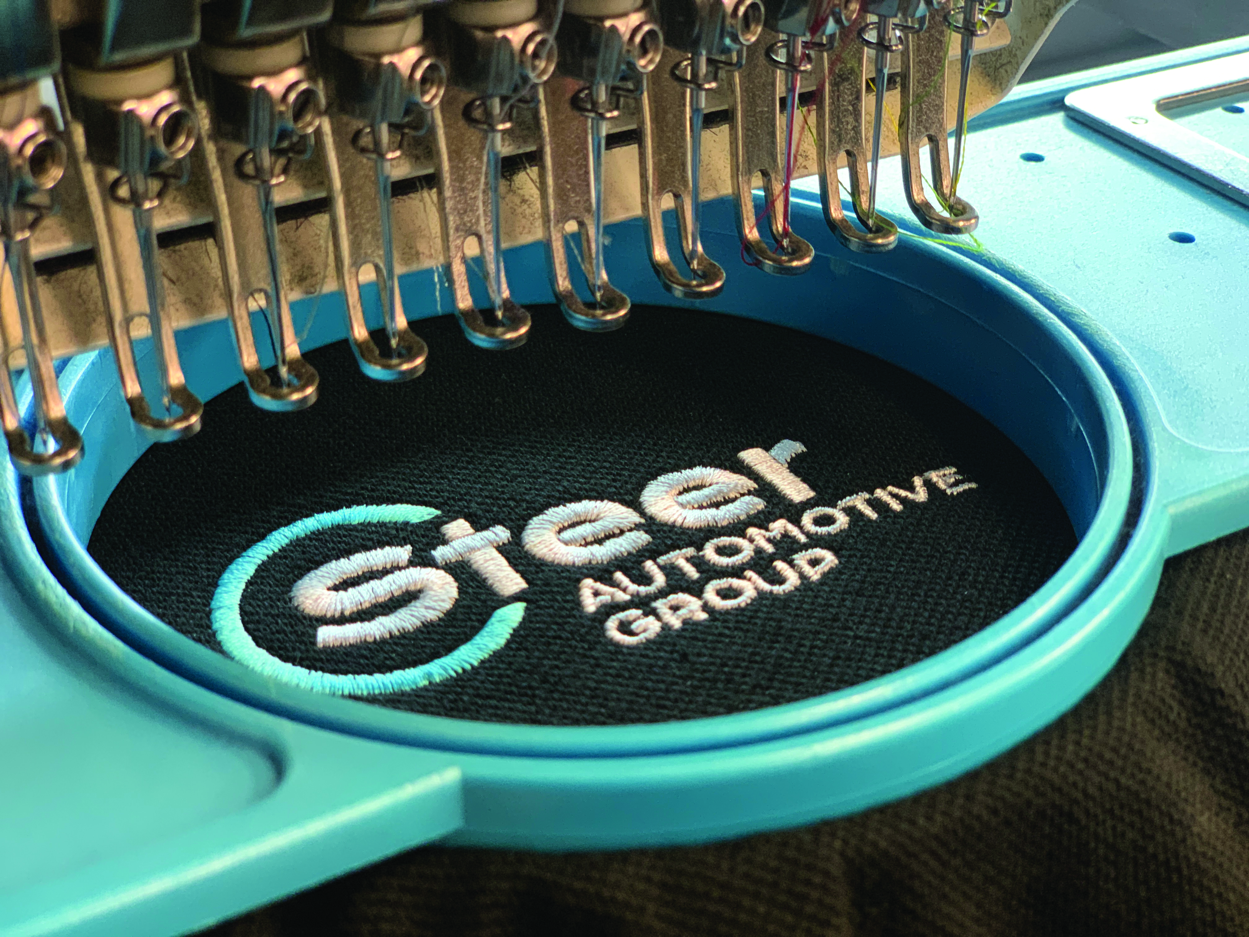 Machine stitching writing on a shirt