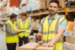 Smiling,Warehouse,Workers,Preparing,A,Shipment,In,A,Large,Warehouse